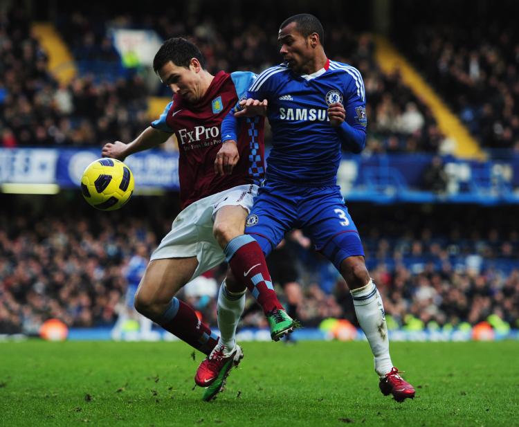 Aston Villa's Stuart Downing and Ashley Cole vie for the ball at Stamford Bridge on Sunday. (Jamie McDonald/Getty Images) Aston Villa's Stuart Downing and Ashley Cole vie for the ball at Stamford Bridge on Sunday. (Jamie McDonald/Getty Images)