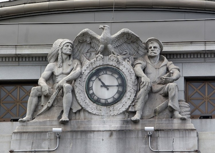 GUARDING TIME: Two sculptured figures above the main entrance on the bank's east facade were created by Charles Keck. (Tim McDevitt/The Epoch Times) GUARDING TIME: Two sculptured figures above the main entrance on the bank's east facade were created by Charles Keck. (Tim McDevitt/The Epoch Times)