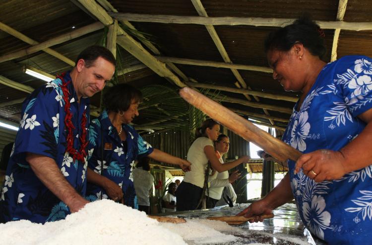 New Zealand Prime Minister John Key (L) visits a coconut plantation in Apia, Samoa, where coconut oil is produced. (Phil Walter/Getty Images)