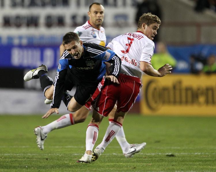San Jose's Bobby Convey may have taken the worst in this collision with New York's Chris Albright, but his two goals and one assist took the Earthquakes past the Red Bulls. (Ezra Shaw/Getty Images)