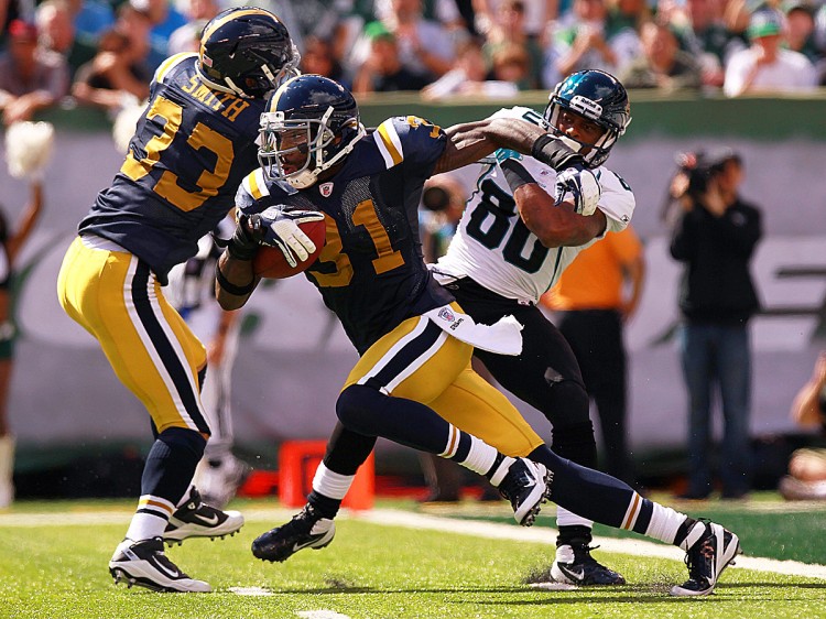 Antonio Cromartie returns one his two interceptions on the day against Jacksonville starter Luke McCown. All in all, the Jets' cornerback (wearing the throw-back blue and yellow uniform) totaled 148 return yards in running back the aforementioned pair of picks plus his two kick returns in the Jets' 32-3 win over Jacksonville. (Nick Laham/Getty Images) Antonio Cromartie returns one his two interceptions on the day against Jacksonville starter Luke McCown. All in all, the Jets' cornerback (wearing the throw-back blue and yellow uniform) totaled 148 return yards in running back the aforementioned pair of picks plus his two kick returns in the Jets' 32-3 win over Jacksonville. (Nick Laham/Getty Images)