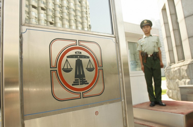 A Chinese paramilitary policeman stands guard outside Beijing's No. 2 Intermediate Court. Chinese lawyers explain that China's legal system is controlled by the Communist Party, not rule of law. (Peter Parksp/AFP/Getty Images)