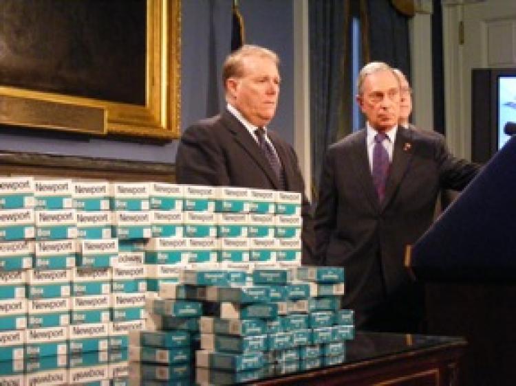 WE GOT 'EM: Chief Policy Adviser John Feinblatt (L) and Mayor Michael Bloomberg present untaxed cigarette packs that were captured in an undercover operation at the Poospatuck Reservation on Long Island. (Gidon Belmaker/Epoch Times Staff) WE GOT 'EM: Chief Policy Adviser John Feinblatt (L) and Mayor Michael Bloomberg present untaxed cigarette packs that were captured in an undercover operation at the Poospatuck Reservation on Long Island. (Gidon Belmaker/Epoch Times Staff)