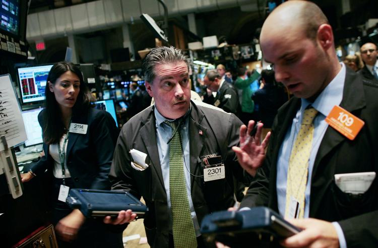 Traders talk on the floor near the end of the trading day at the New York Stock Exchange yesterday. Stocks closed down more than 700 points on Wednesday. (Chris Hondros/Getty Images) Traders talk on the floor near the end of the trading day at the New York Stock Exchange yesterday. Stocks closed down more than 700 points on Wednesday. (Chris Hondros/Getty Images)