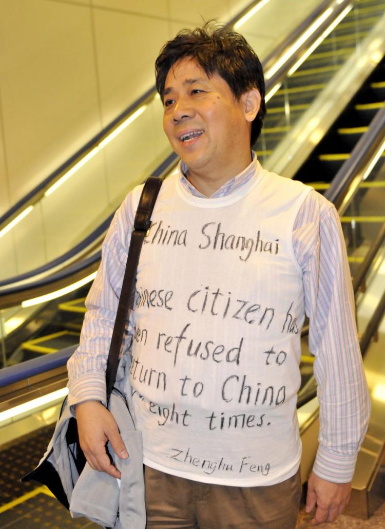 Chinese human rights activist Feng Zhenghu wears a shirt with his appeal written on it as he speaks with an AFP reporter at the Narita International Airport, near Tokyo, on Nov. 12.  (Yoshikazu Tsuno/AFP/Getty Images)