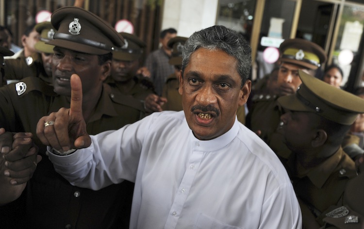Sri Lanka's jailed ex-army chief and opposition leader Sarath Fonseka gestures as he arrives at the Court of Colombo, January 25, 2012. (Ishara S. Kodikara/AFP/GettyImages) Epoch Times Photo