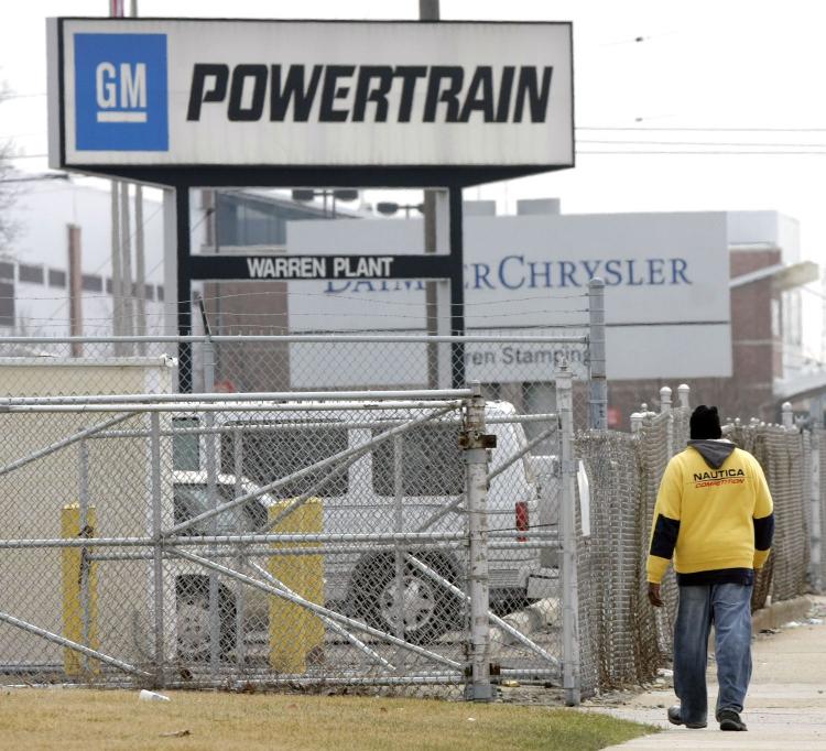 A man walks past the General Motors Powertrain Plant and toward the Chrysler Truck Plant in Warren, Michigan. GM announced last week that 7,500 United Auto Workers union members have accepted buyouts and early retirement packages. (Bill Pugliano/Getty Images) A man walks past the General Motors Powertrain Plant and toward the Chrysler Truck Plant in Warren, Michigan. GM announced last week that 7,500 United Auto Workers union members have accepted buyouts and early retirement packages. (Bill Pugliano/Getty Images)