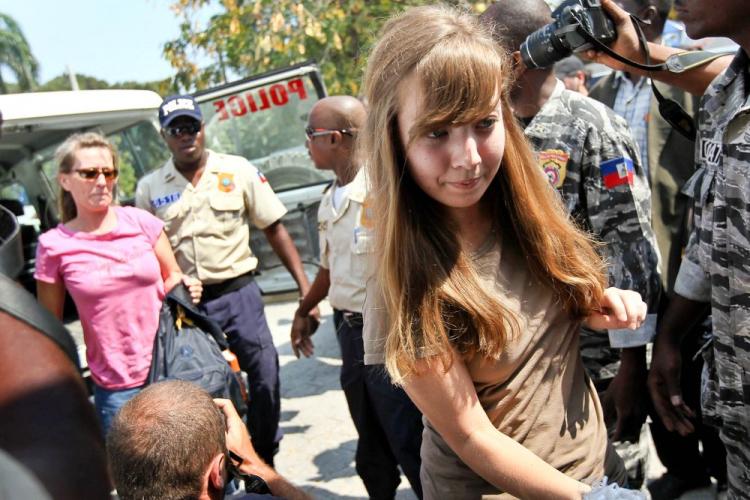 Silas Thompson of Twin Falls, Idaho, (in red) and Jim Allen of Amarillo, Texas (R), members of New Life Children's Refuge accused of child trafficking, are escorted into a court hearing on Feb. 4, 2010, in Port-au-Prince, Haiti. The five women and five men are part of a church organization that attempted to cross into the Dominican Republic with 33 Haitian children. (John Moore/Getty Images)