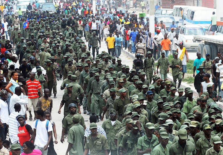 Former Haitian soldiers march to demand the return of the Haitian army during a May 18 protest near the UN post in the Carrefour neighborhood of Port-au-Prince. (Thony Belizaire/AFP/GettyImages) Epoch Times Photo