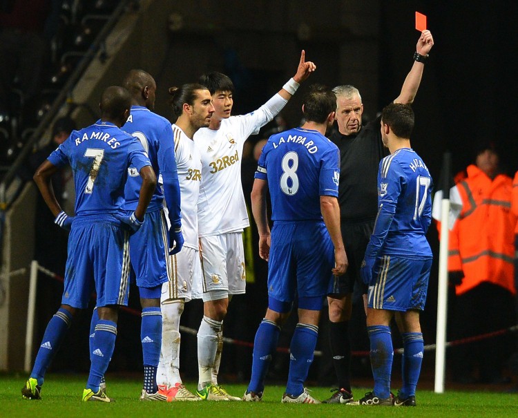 FBL-ENG-LCUP-SWANSEA-CHELSEA Eden Hazard of Chelsea (R) is shown a red car for having kicked a ball boy in the Carling Cup semifnal against Swansea City on Wednesday, Jan. 23, 2013. (Andrew Yates/AFP/Getty Images)