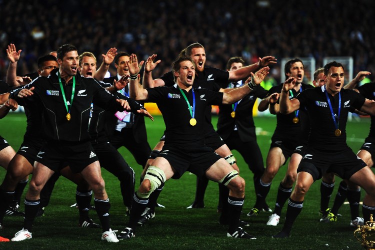 The All Blacks perform the Haka with their championship medals and beside the Webb Ellis trophy. (Mike Hewitt/Getty Images)