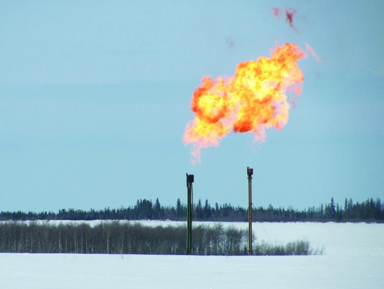 Twin flarestacks are cleaned through 'flaring' at a wellsite near Farmington, B.C., in March 2010. Flarestacks are a common site near homes in B.C.'s Peace region. (Courtesy of Ken John.) Twin flarestacks are cleaned through 'flaring' at a wellsite near Farmington, B.C., in March 2010. Flarestacks are a common site near homes in B.C.'s Peace region. (Courtesy of Ken John.)
