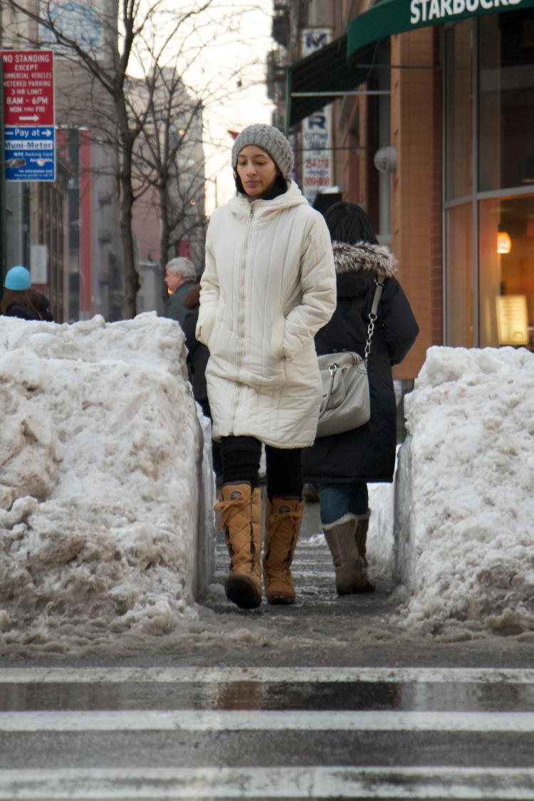 New York City pedestrians navigate narrow pathways through snowplowed streets and slushy puddles on sidewalks as the city recovers from Sunday's blizzard. (Tim McDevitt/The Epoch Times) New York City pedestrians navigate narrow pathways through snowplowed streets and slushy puddles on sidewalks as the city recovers from Sunday's blizzard. (Tim McDevitt/The Epoch Times)