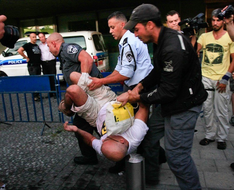 Police arrest housing crisis demonstrators at the back entrance of City Hall on Wednesday. (Yaira Yasmin/The Epoch Times) Police arrest housing crisis demonstrators at the back entrance of City Hall on Wednesday. (Yaira Yasmin/The Epoch Times)