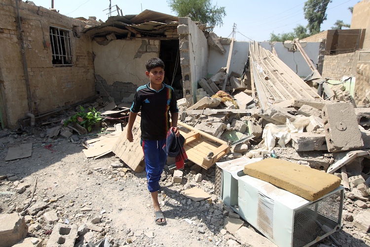 Elven-year-old Mohammad searches for salvageable items amid the rubble of his family's destroyed house following a series of bomb attacks in the town of Taji, north of Baghdad on July 23. (Ahmad Al-RubayeAFP/GettyImages)