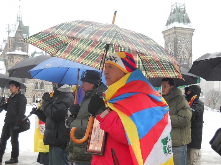 Jhupten Champa stands on Parliament Hill with a small crowd of fellow Tibetans and supporters on Thursday to mark the anniversary of the 1952 Tibetan uprising. (Matthew Little/The Epoch Times)