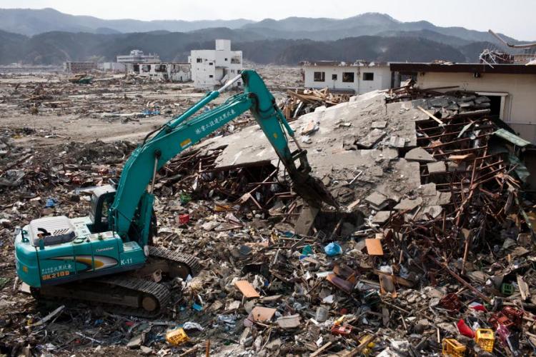 Japanese workers use a hydraulic machine to demolish a wrecked building in the tsunami-devastated town of Rikuzentakata, Iwate prefecture, on April 2, 2011. (Yasuyoshi Chiba/AFP/Getty Images) Japanese workers use a hydraulic machine to demolish a wrecked building in the tsunami-devastated town of Rikuzentakata, Iwate prefecture, on April 2, 2011. (Yasuyoshi Chiba/AFP/Getty Images)