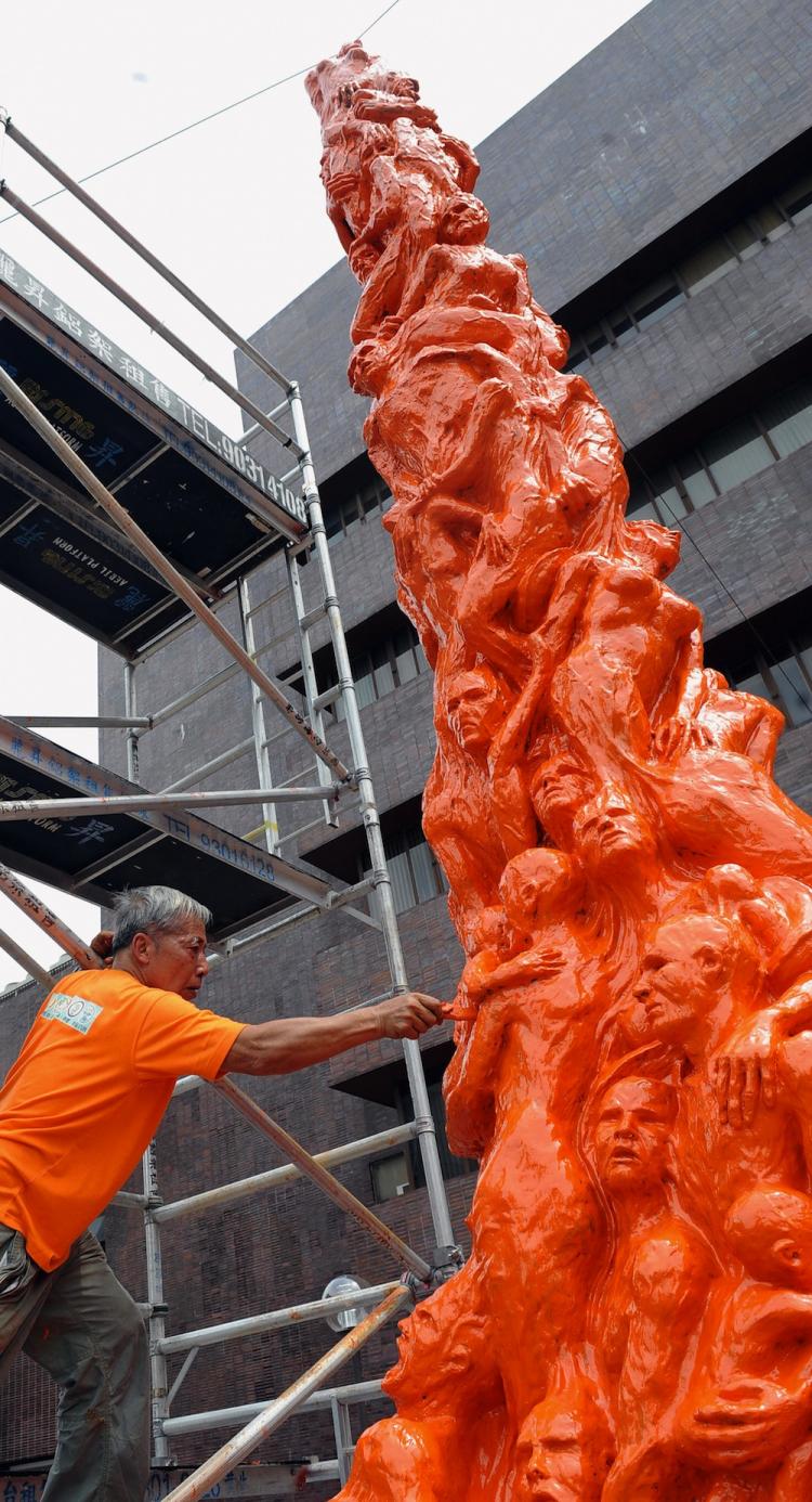 Danish artist Jens Galschiot painted his artwork Pillar of Shame orange, a color symbolizing discontent with the Chinese regime. (Ted Aljibe/Getty Images) Danish artist Jens Galschiot painted his artwork Pillar of Shame orange, a color symbolizing discontent with the Chinese regime. (Ted Aljibe/Getty Images)