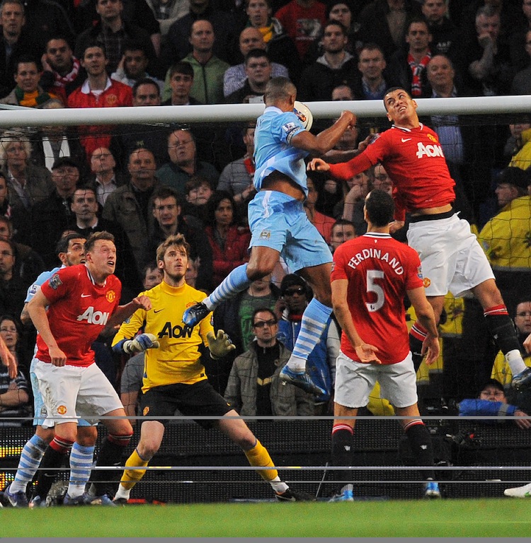 Manchester City's Belgian footballer Vin Vincent Kompany rises above the Manchester United defenders to put Manchester City ahead. (Andrew Yates/AFP/Getty Images)