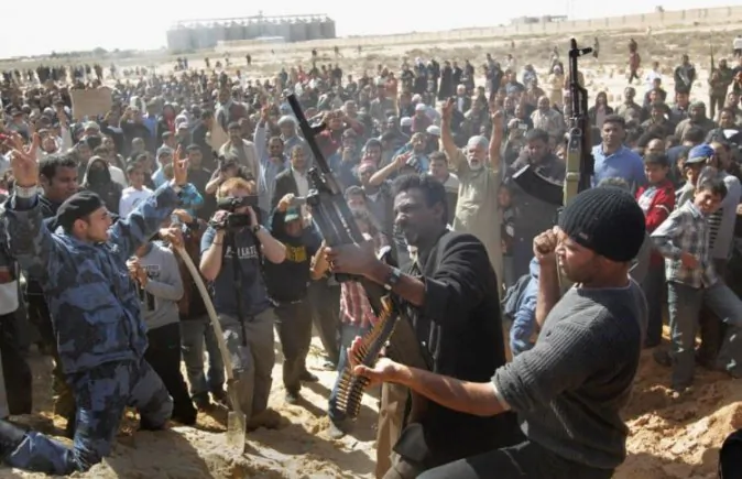 Rebel fighters shoot into the air during a funeral for slain comrades on March 3, in Ajdabiya, Libya. (John Moore/Getty Images)