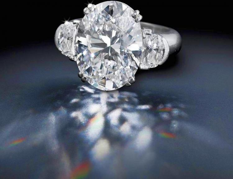 DIAMOND SOLITAIRE RING: The oval-shaped diamond, weighing 10.17 carats, with half-moon diamond shoulders; mounted in platinum; size 6. Estimate: $550,000 - 650,000 (Courtesy of Bonhams New York)