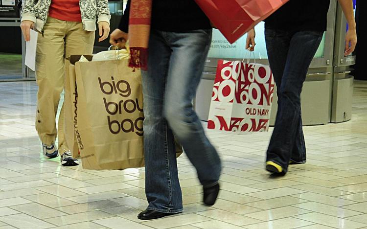 Holiday shoppers carry bags with their purchases through the Tysons Corner mall in Tysons Corner, Virginia last month.  (KAREN BLEIER/AFP/Getty Images)