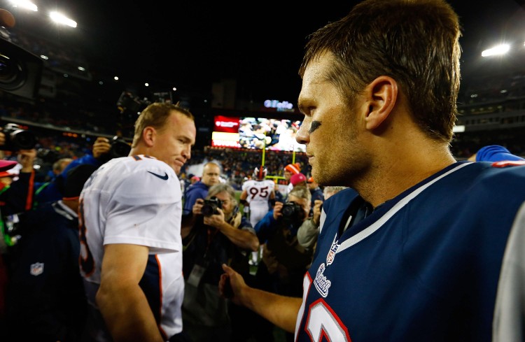 Denver's Peyton Manning and New England's Tom Brady meet near the centre field at Gillette Stadium on Oct. 7 after the Patriots beat the Broncos. (Jared Wickerham/Getty Images) 