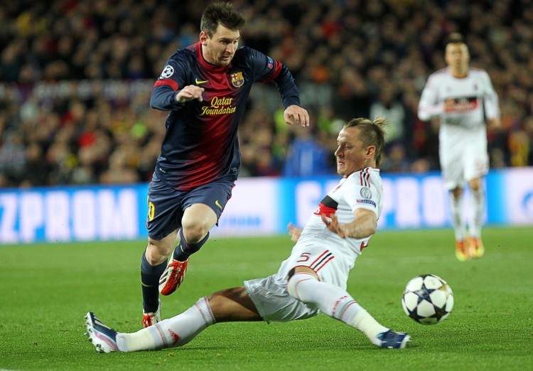FBL-EUR-C1-BARCELONA-MILAN Barcelona's Lionel Messi moves past AC Milan defender Philippe Mexes in Champions League action in Barcelona on Mar. 12, 2013. (Quique Garcia/AFP/Getty Images)