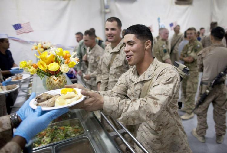 U.S. Marines are served turkey dinners in the main dining facility during the annual Thanksgiving meal at Camp Leatherneck last week. A recommendation to extend federal pay freezes to military personnel excludes Iraq and Afghanistan troops. (Paula Bronstein/Getty Images) U.S. Marines are served turkey dinners in the main dining facility during the annual Thanksgiving meal at Camp Leatherneck last week. A recommendation to extend federal pay freezes to military personnel excludes Iraq and Afghanistan troops. (Paula Bronstein/Getty Images)