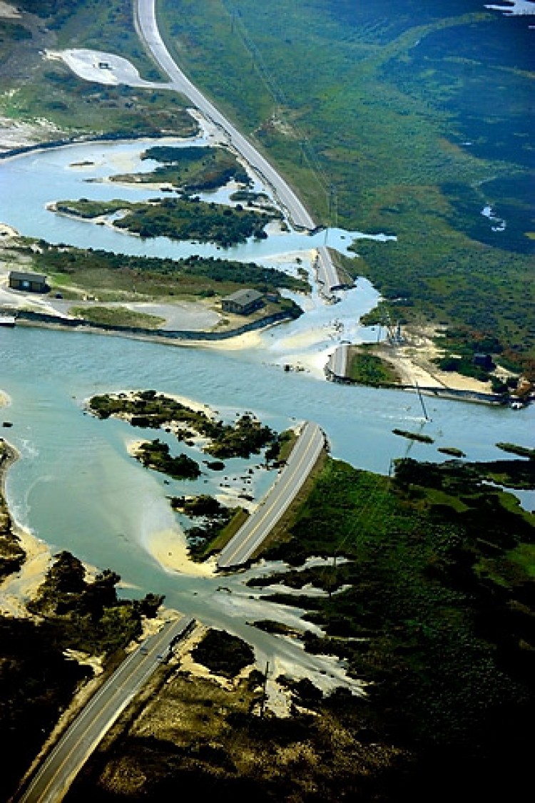 An aerial shot provided by the Coast Guard shows flooding and damage to roadways near Oregon Inlet Aug. 29, near Elizabeth City, N.C. Gov. Perry is calling for a temporary bridge to be built to assist isolated islanders in the Outer Banks. (Stephen Lehmann/U.S. Coast Guard via Getty Images) An aerial shot provided by the Coast Guard shows flooding and damage to roadways near Oregon Inlet Aug. 29, near Elizabeth City, N.C. Gov. Perry is calling for a temporary bridge to be built to assist isolated islanders in the Outer Banks. (Stephen Lehmann/U.S. Coast Guard via Getty Images)