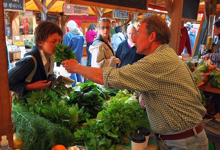 A local buys vegetables at the Matakana Famers Market near Auckland