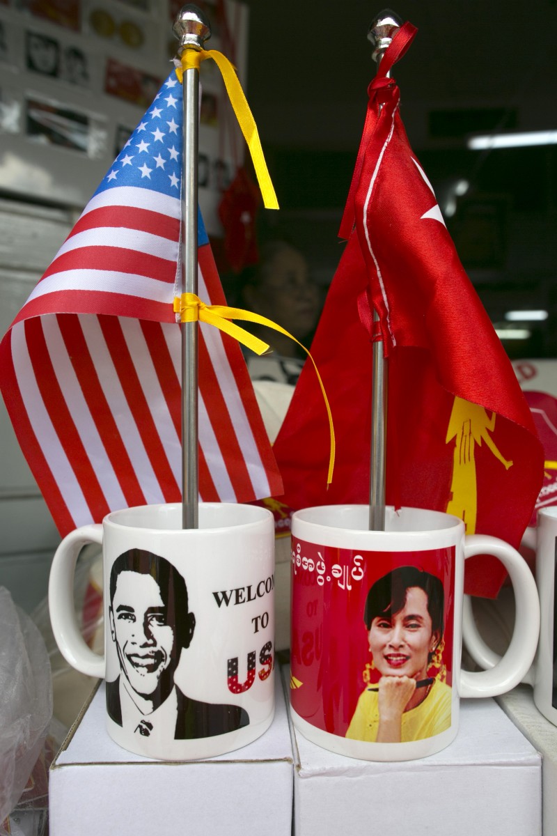 Mugs and flags showing US President Barack Obama and Burmese opposition leader Aung San Suu Kyi are displayed in a shop in Yangon Burma as the city prepares for the US Presidents forthcoming visit on November 16. (Photo by Paula Bronstein/Getty Images) Mugs and flags showing US President Barack Obama and Burmese opposition leader Aung San Suu Kyi are displayed in a shop in Yangon Burma as the city prepares for the US Presidents forthcoming visit on November 16. (Photo by Paula Bronstein/Getty Images)