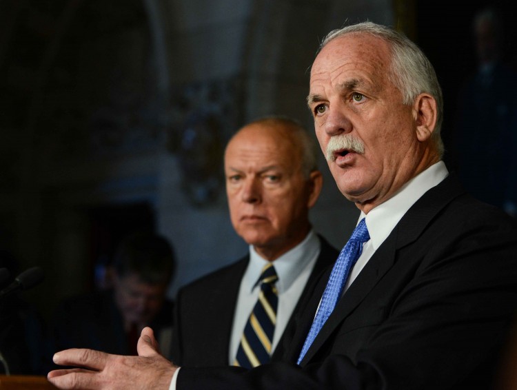 PS-Minister-Vic-Toews-2012-2012_12_11_4196_ML Canadian Public Safety Minister Vic Toews details changes he introduced to the Witness Protection Program Act to reporters on Parliament Hill on Dec. 11, 2012, as Senator Jean-Guy Dagenais looks on. (Matthew Little/The Epoch Times)