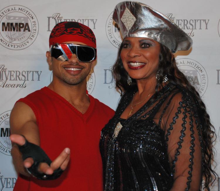 Raz-B, former member of R&B boy band B2K, alongside dancer Guadalupae D'Lushus at the MMPA 10th Annual Holiday Toy Drive Extravaganza. (Robin Kemker/Epoch Times) Raz-B, former member of R&B boy band B2K, alongside dancer Guadalupae D'Lushus at the MMPA 10th Annual Holiday Toy Drive Extravaganza. (Robin Kemker/Epoch Times)