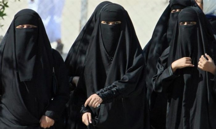 Saudi women cross a street in Hofuf, Saudi Arabia, on Nov. 22, 2007. (Hassan Ammar/AFP/Getty Images)