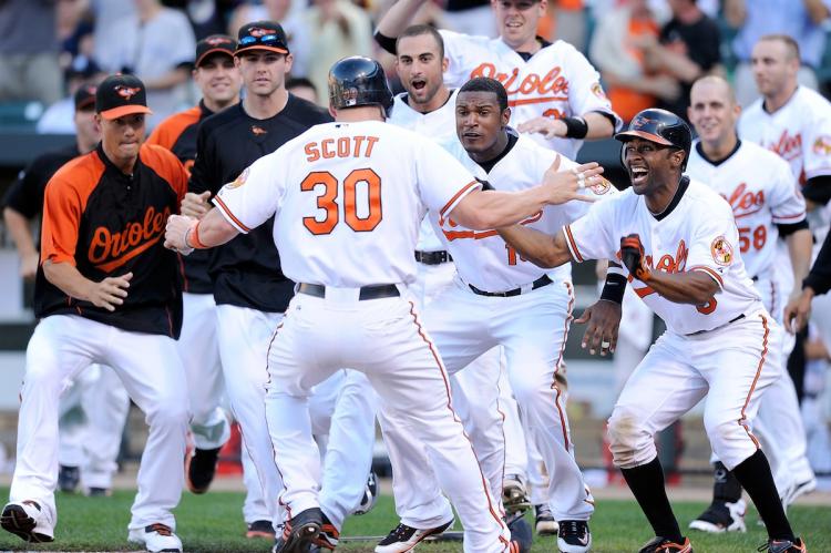 CELEBRATION: Luke Scott of the Baltimore Orioles is cheered on by his teammates after scoring Sunday's 11th inning game-winning run against the New York Yankees. CELEBRATION: Luke Scott of the Baltimore Orioles is cheered on by his teammates after scoring Sunday's 11th inning game-winning run against the New York Yankees.
