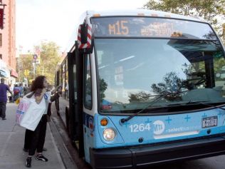 MTA Subway bus Passengers board the M15 SBS express bus at the corner of E. Houston Street and Allen Street on its first day running, Oct. 12, 2010. (Tara MacIsaac/The Epoch Times)