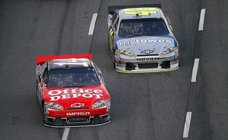 Jimmie Johnson in the #48 MyLowe's Chevrolet (R), races Tony Stewart in the #14 Office Depot/Mobil 1 Chevrolet in the final laps of the TUMS Fast Relief 500 at Martinsville Speedway. (Streeter Lecka/Getty Images)