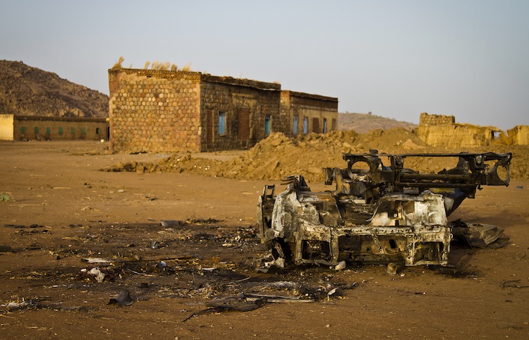 Photo taken on April 3, shows the shell of a vehicle that was hit by a bomb in the abandoned village of Trogi during fighting in South Kordofan, Sudan. (Adriane Ohanesian/AFP/Getty Images) Epoch Times Photo