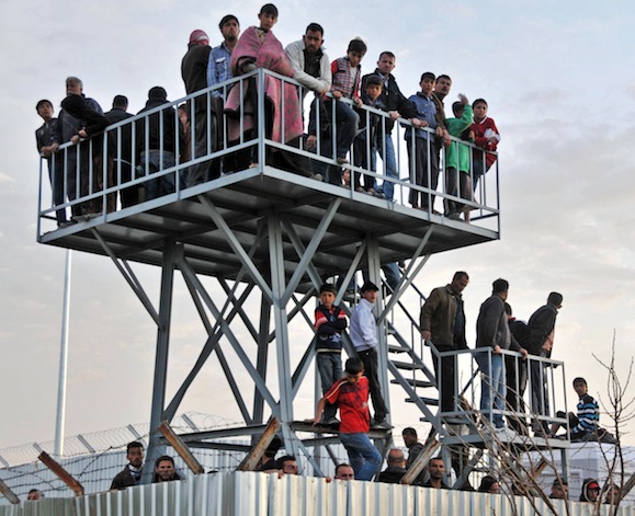Syrian refugees watch the border. Epoch Times Photo