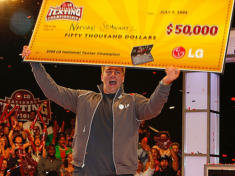 FASTEST FINGERS: Nathan Schwartz, 20, of Ohio holds his check for $50,000 after winning the LG National Texting Competition on Wednesday. (Edward Dai/The Epoch Times) FASTEST FINGERS: Nathan Schwartz, 20, of Ohio holds his check for $50,000 after winning the LG National Texting Competition on Wednesday. (Edward Dai/The Epoch Times)