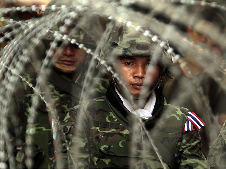 LOOKING FOR CONTROL: Thai soldiers stand guard as red shirt supporters of ousted Prime Minister Thaksin Shinawatra threaten to take their protest to Bangkok's financial district.  (Luis Ascui/Getty Images)