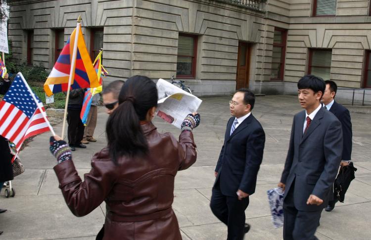 Chinese officials walk toward Tibetan protesters after visiting Portland City Hall on March 8. (Jampa Lhatsang/www.TibetanPrayerFlag.com) Chinese officials walk toward Tibetan protesters after visiting Portland City Hall on March 8. (Jampa Lhatsang/www.TibetanPrayerFlag.com)
