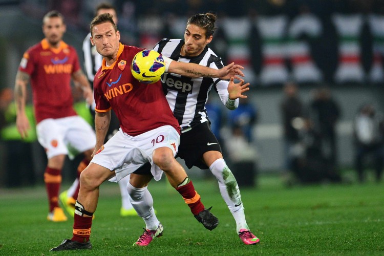FBL-ITA-SERIEA-ROMA-JUVENTUS AS Roma's Francesco Totti shields the ball from Juventus defender Martin Caceres at the Olympic Stadium in Rome on Feb. 16, 2013. (Giuseppe Cacece/AFP/Getty Images)