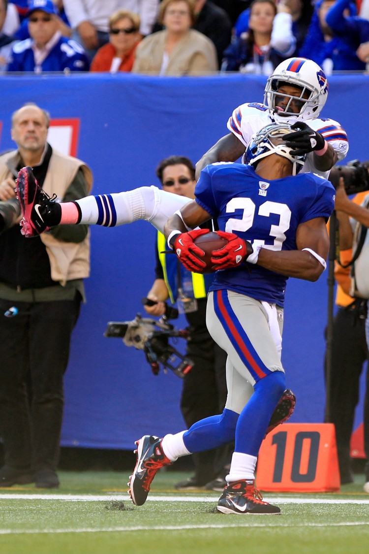 Corey Webster (23) is able to hang on, despite Bills' receiver Steve JohNson's facemasking, for his second interception of the day. The play changed the momentum as instead of giving up an almost-certain score New York drove down for the game-winning field goal. (Chris Trotman/Getty Images) Corey Webster (23) is able to hang on, despite Bills' receiver Steve JohNson's facemasking, for his second interception of the day. The play changed the momentum as instead of giving up an almost-certain score New York drove down for the game-winning field goal. (Chris Trotman/Getty Images)