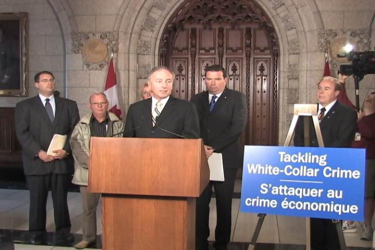 FIGHTING FRAUD: Minister of Justice and Attorney General of Canada Rob Nicholson speaking to the press on Parliament Hill Sept. 15 about the government's intention to introduce legislation to combat white-collar crime. To his right is Minister of Public W (NTDTV) FIGHTING FRAUD: Minister of Justice and Attorney General of Canada Rob Nicholson speaking to the press on Parliament Hill Sept. 15 about the government's intention to introduce legislation to combat white-collar crime. To his right is Minister of Public W (NTDTV)