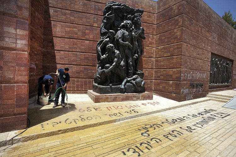 Workers wash away anti-Zionist Hebrew graffiti Workers wash away anti-Zionist Hebrew graffiti