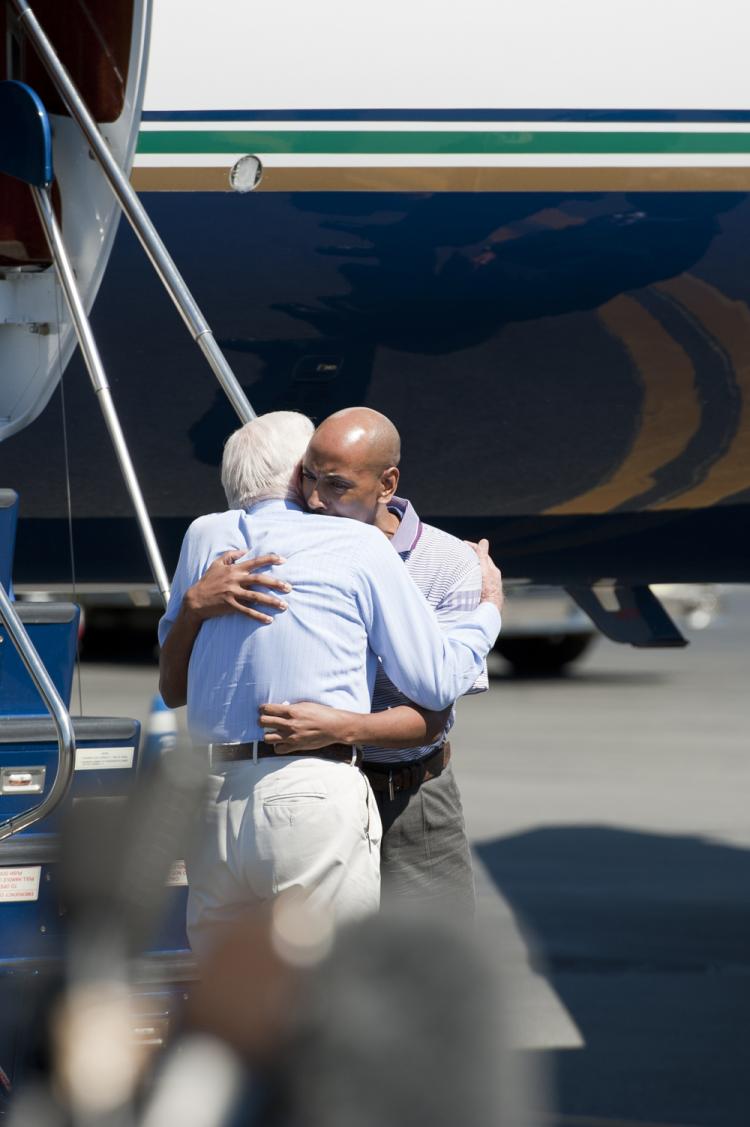 Jimmy Carter (L), former U.S. president, hugs Aijalon Mahli Gomes, a Boston native who was detained in North Korea for eight months, at the Boston Logan Airport upon their landing. (Riordan Galluccio/The Epoch Times)