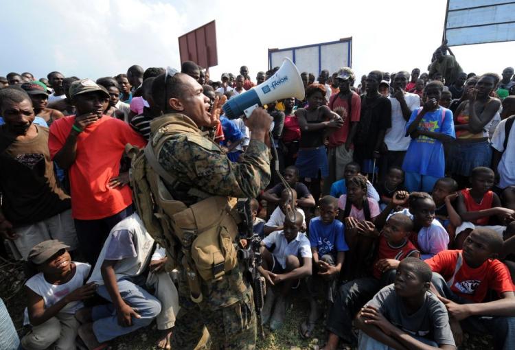 Haitian earthquake victims listen to a U.S. Marine in Leogan on Jan. 20. The logistics of transporting needed supplies is an ongoing dilemma in Haiti which was hit by a 6.1 magnitude aftershock early Wednesday morning. (Jewel Samad/AFP/Getty Images) Haitian earthquake victims listen to a U.S. Marine in Leogan on Jan. 20. The logistics of transporting needed supplies is an ongoing dilemma in Haiti which was hit by a 6.1 magnitude aftershock early Wednesday morning. (Jewel Samad/AFP/Getty Images)