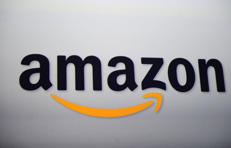 The Amazon logo is projected on a screen Epoch Times Photo